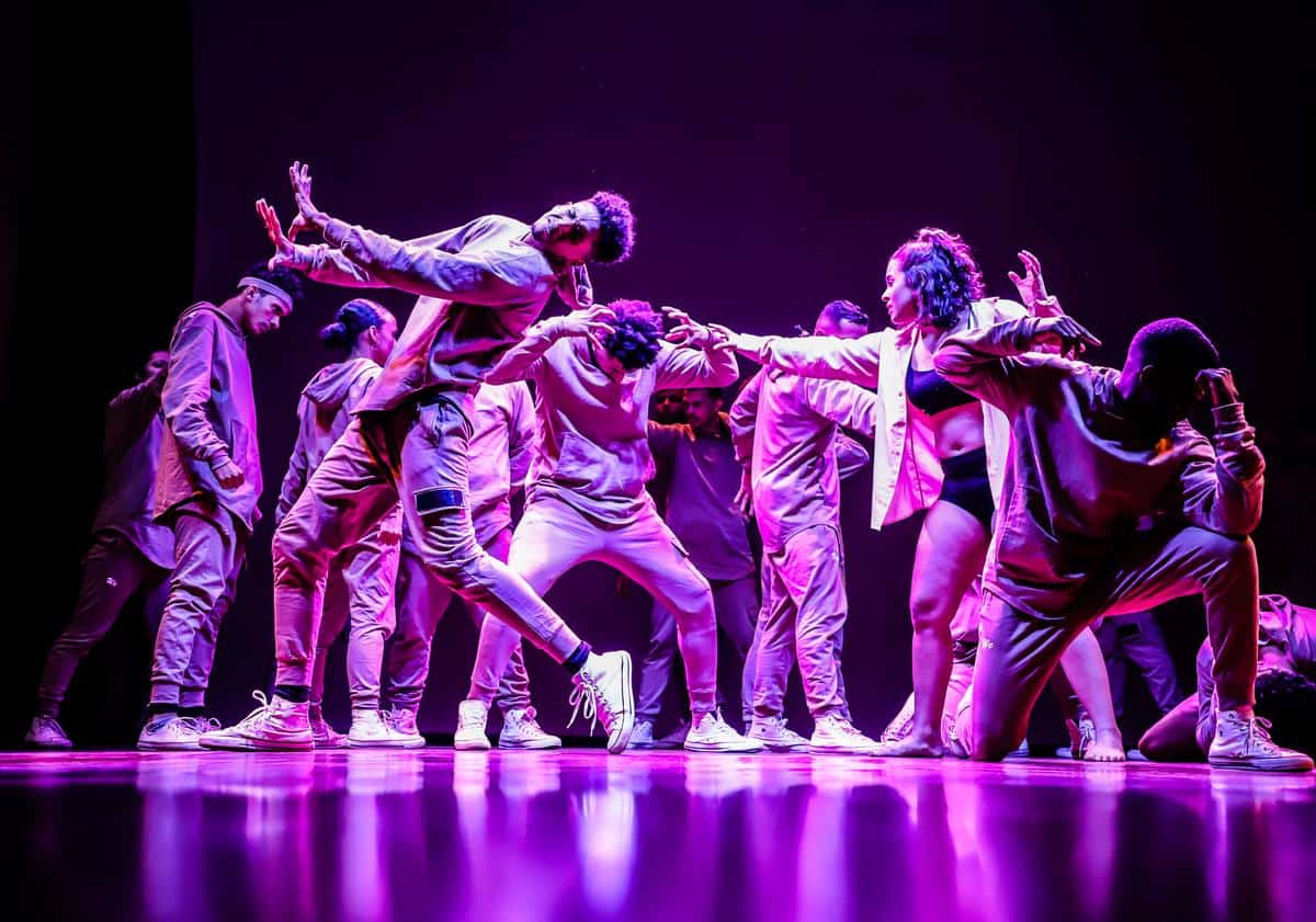 A vibrant and energetic dance performance in a K-pop style, depicting the immense joy and passion of the dancers.
