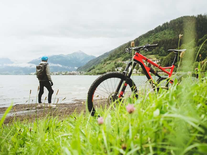 Image of a person inspecting an electric full suspension mountain bike during a routine inspection